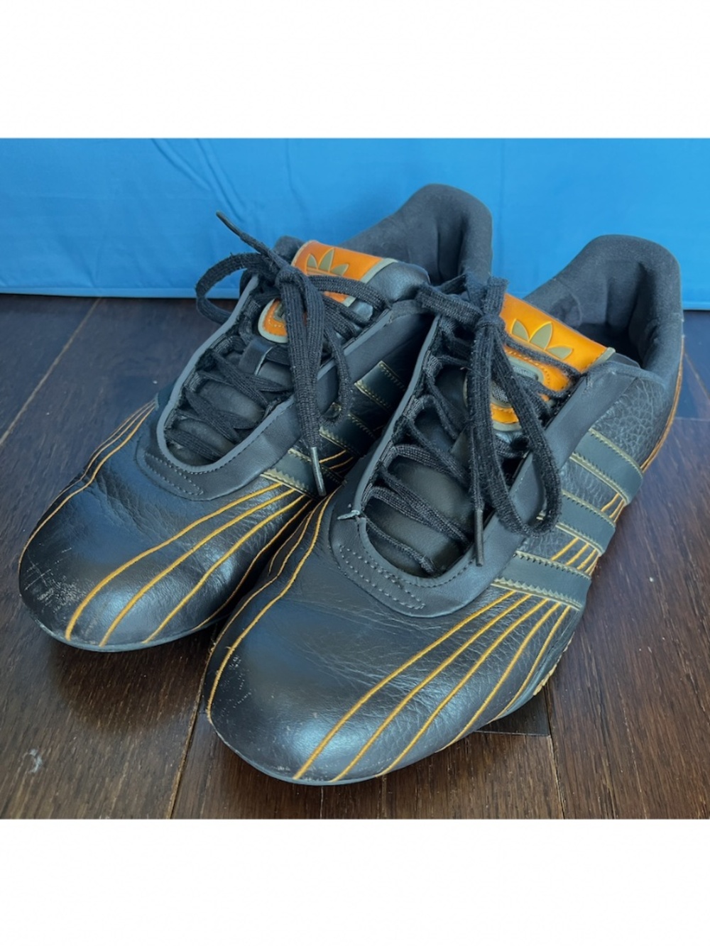 Used Men's Adidas Goodyear Brown Racing Sneakers Size 8. Fair Condition.